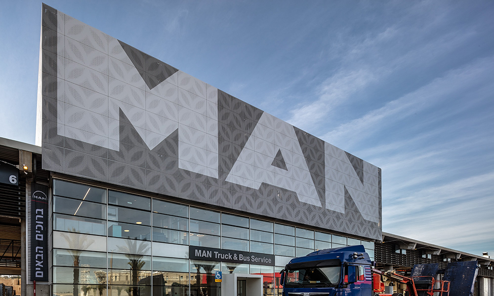 a large building with a bus parked in front of it